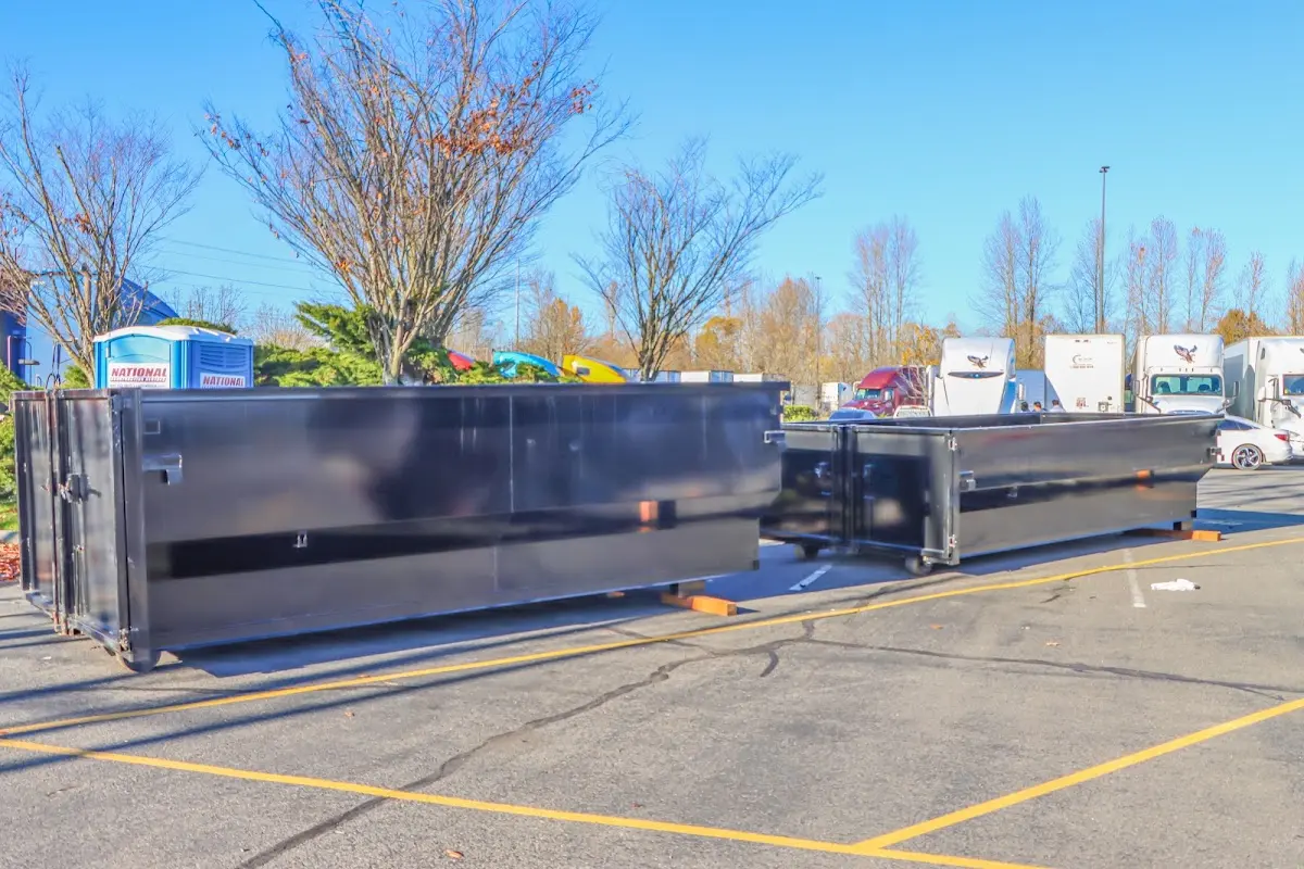 Professional dumpster rental service with roll-off container on residential driveway in Coeur d'Alene